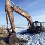 Photo of backhoe and grasses and snow