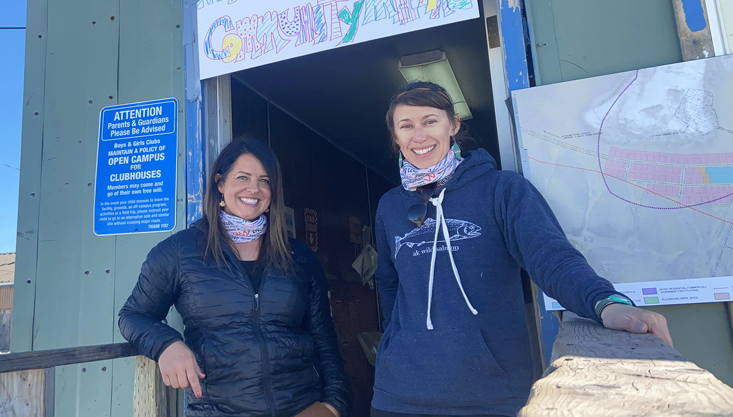 Two CRW employees standing outside a community clubhouse